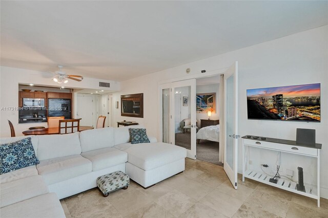 living room with ceiling fan and french doors