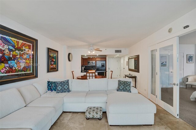 living room featuring french doors and ceiling fan