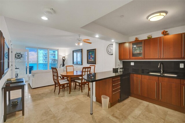 kitchen featuring floor to ceiling windows, sink, black dishwasher, kitchen peninsula, and backsplash