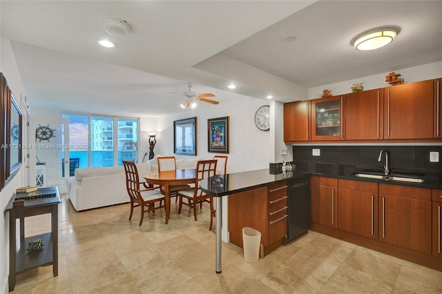 kitchen featuring sink, tasteful backsplash, black dishwasher, kitchen peninsula, and ceiling fan