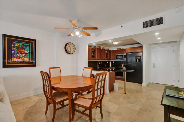 dining area featuring sink and ceiling fan