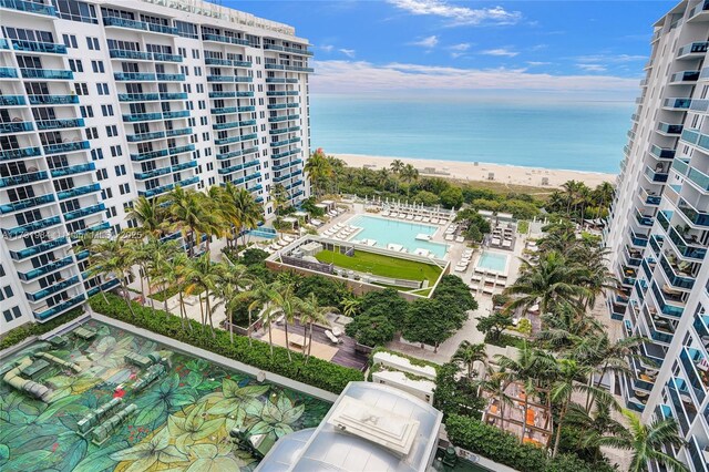 exterior space featuring a water view and a beach view