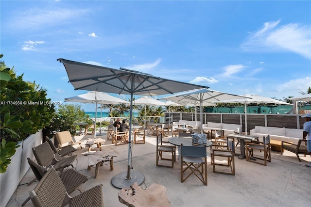 view of patio / terrace featuring a water view and an outdoor living space