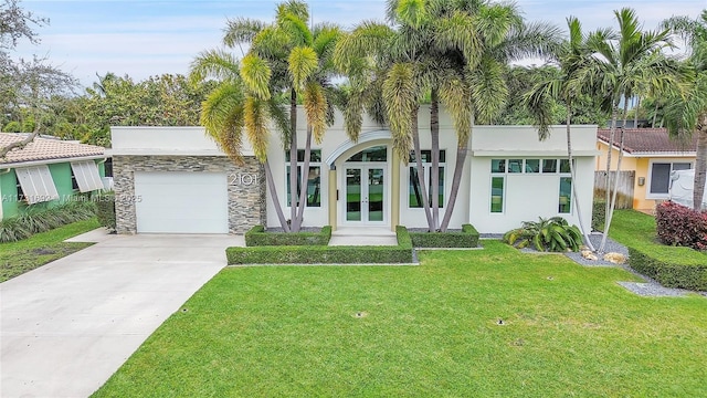 view of front facade featuring a garage, a front lawn, and french doors