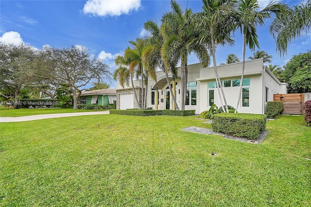 view of front of home with a garage and a front yard