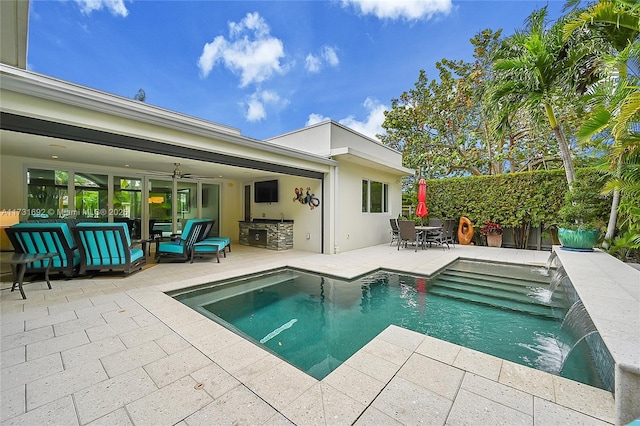 view of swimming pool featuring pool water feature, a patio area, area for grilling, outdoor lounge area, and ceiling fan