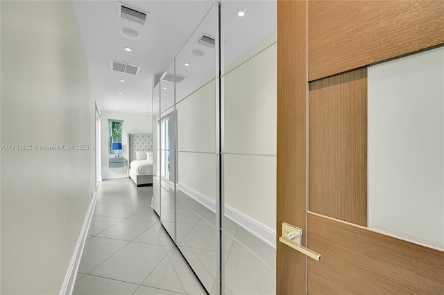 hall featuring light tile patterned floors