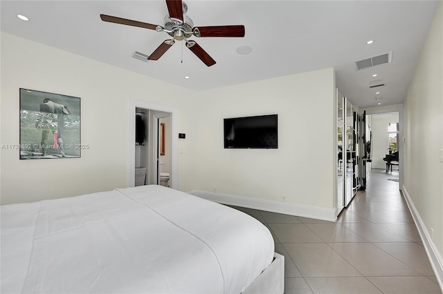 bedroom featuring ensuite bathroom, tile patterned floors, and ceiling fan