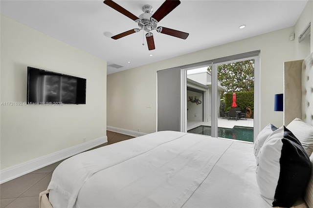 bedroom with ceiling fan, dark tile patterned floors, and access to outside