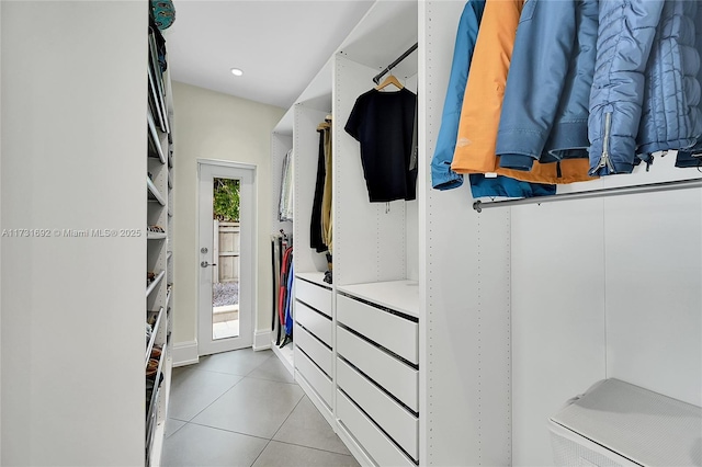 walk in closet featuring light tile patterned flooring