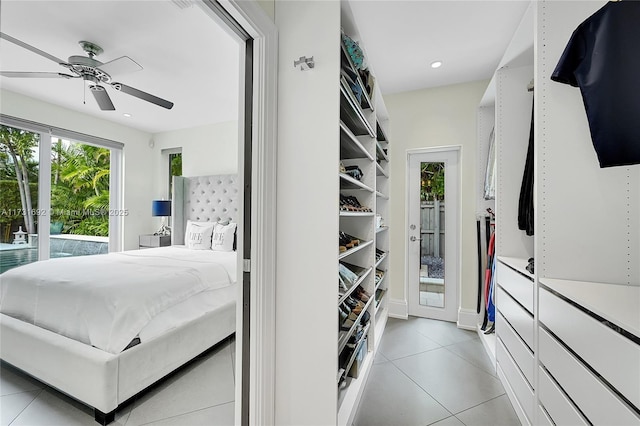 walk in closet with light tile patterned floors and ceiling fan