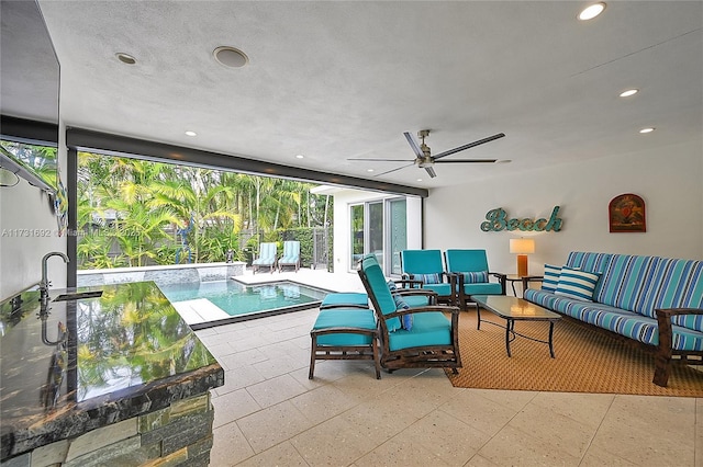 interior space featuring ceiling fan, an outdoor living space, and sink