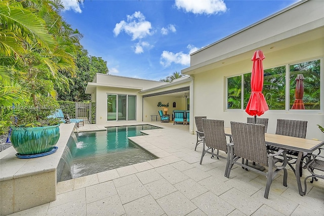 view of pool featuring pool water feature, ceiling fan, and a patio area