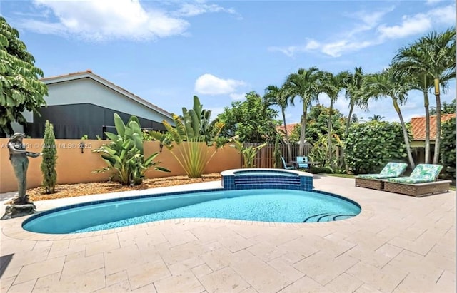 view of swimming pool featuring an in ground hot tub and a patio