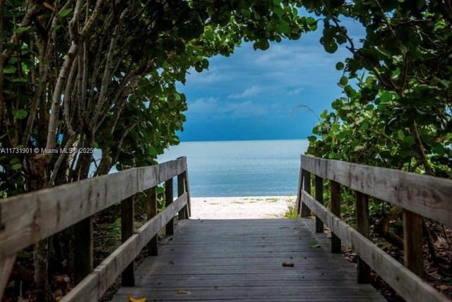 exterior space featuring a water view and a beach view