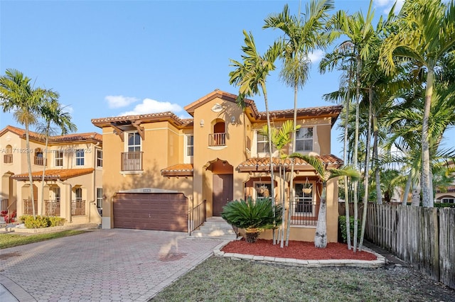 mediterranean / spanish-style house with a garage