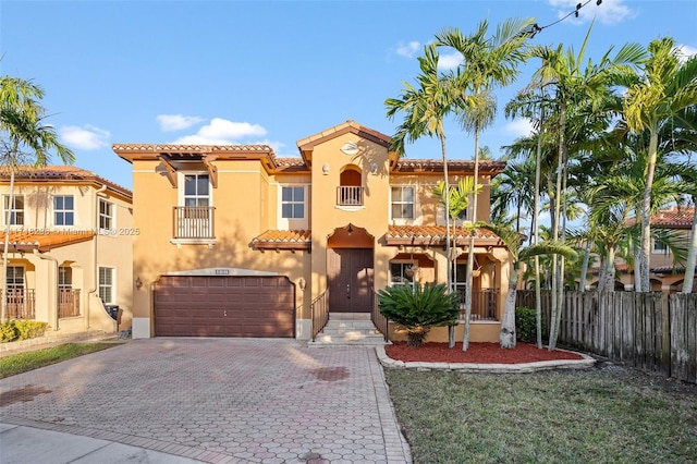 mediterranean / spanish-style house with a garage