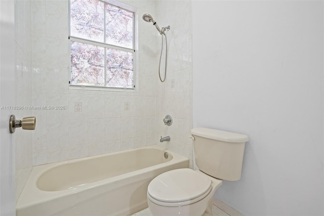 bathroom featuring tiled shower / bath and toilet