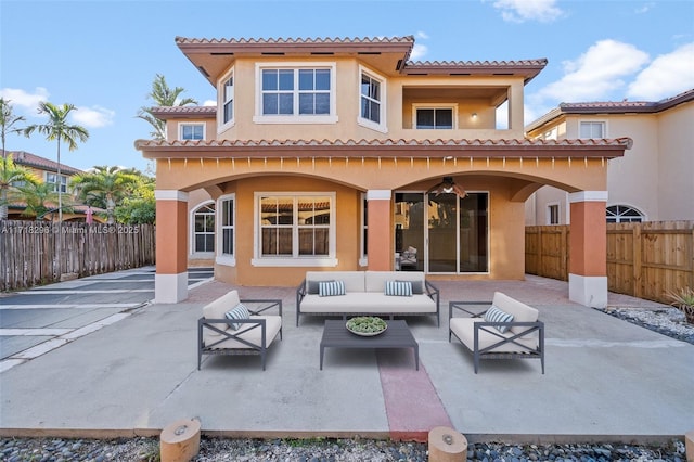 back of property featuring an outdoor living space and a patio area