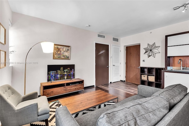 living room with sink and dark hardwood / wood-style flooring