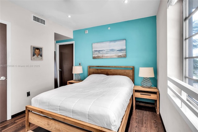 bedroom with dark wood-type flooring