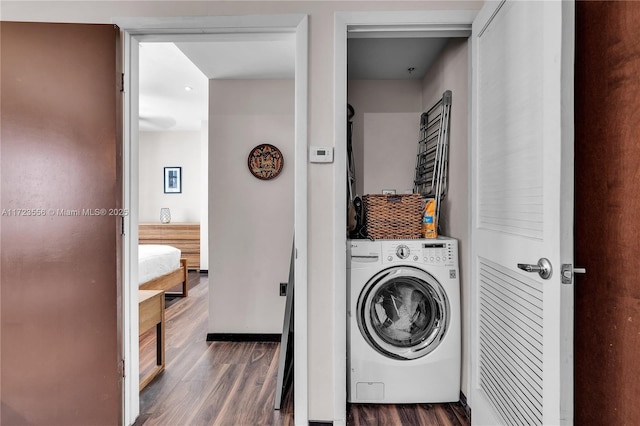 laundry area featuring washer / clothes dryer and dark wood-type flooring