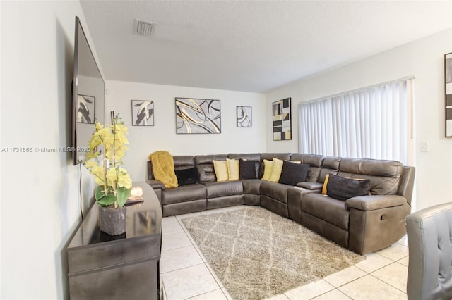 tiled living room with a textured ceiling