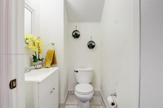 bathroom featuring vanity, toilet, and tile patterned flooring