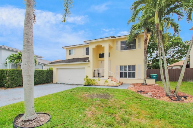 mediterranean / spanish home with a garage and a front yard