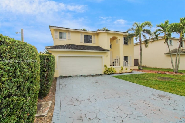 view of front of property with a garage and a front yard