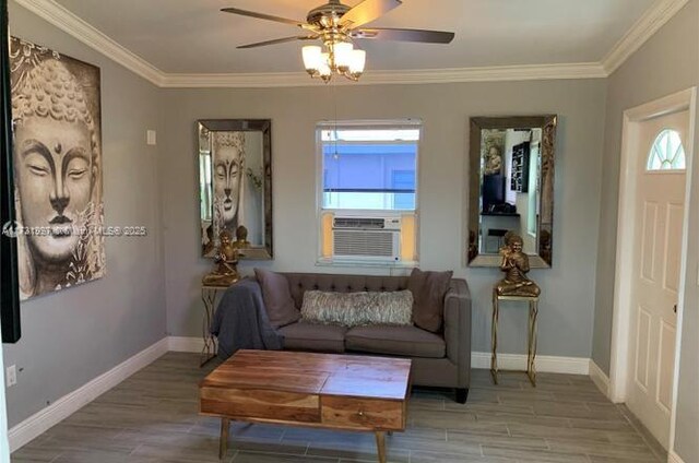 living area with crown molding, a healthy amount of sunlight, and light hardwood / wood-style flooring