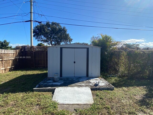 view of outbuilding with a yard