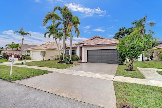 view of front of property with a garage and a front lawn