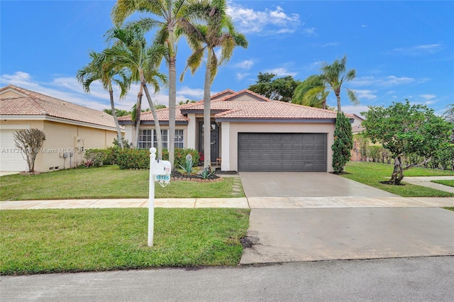 mediterranean / spanish-style house featuring a garage and a front yard