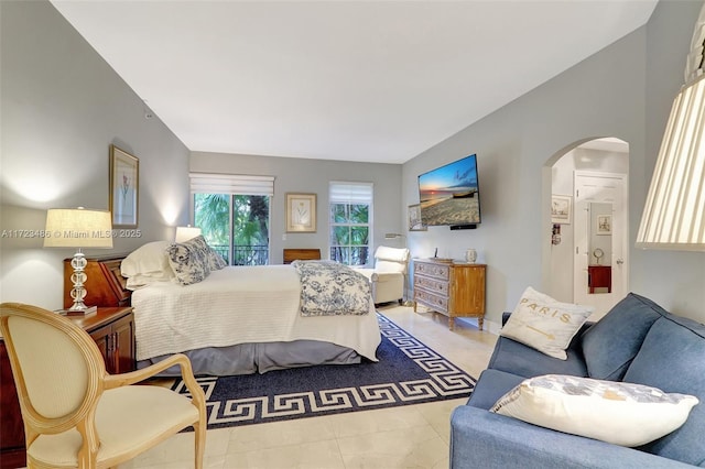 bedroom featuring light tile patterned flooring and access to exterior