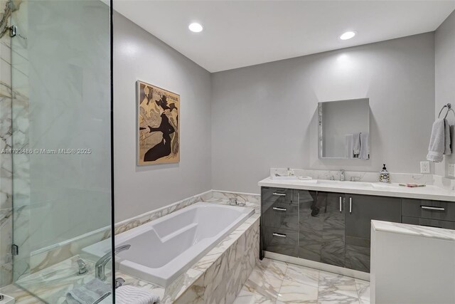 bathroom with vanity and independent shower and bath