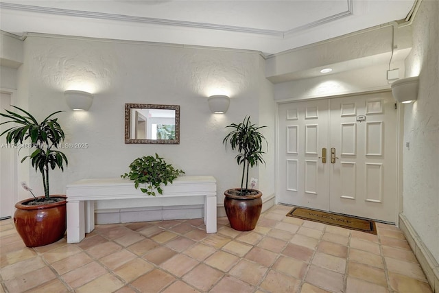 foyer featuring ornamental molding