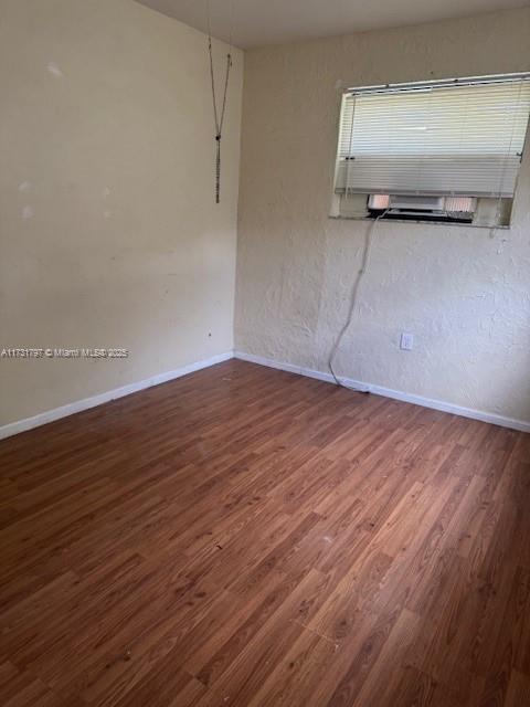 empty room featuring dark wood-type flooring