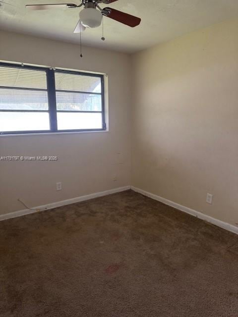 carpeted empty room featuring ceiling fan