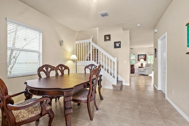 dining area with light tile patterned floors