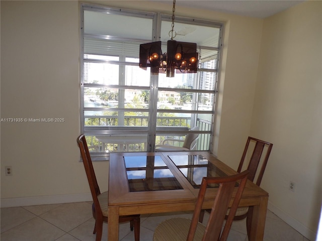 tiled dining space featuring a chandelier