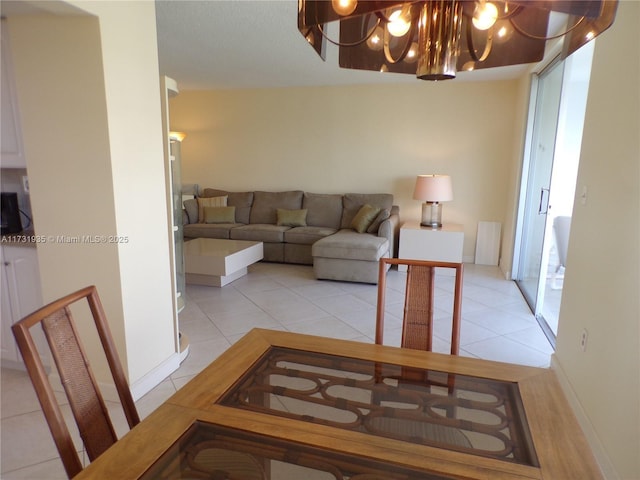 living room with a chandelier and light tile patterned flooring