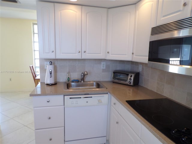 kitchen with sink, backsplash, white dishwasher, black electric stovetop, and white cabinets