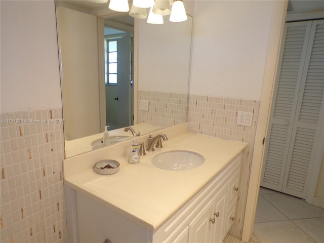 bathroom with tile patterned floors, tile walls, and vanity