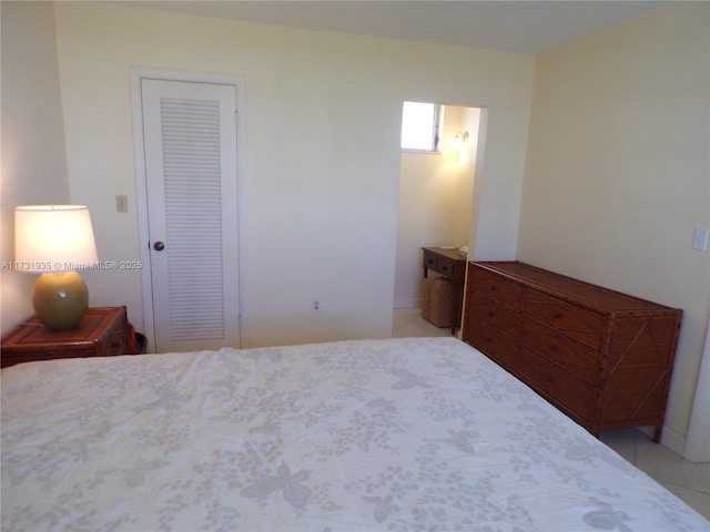 unfurnished bedroom with light tile patterned flooring and a closet