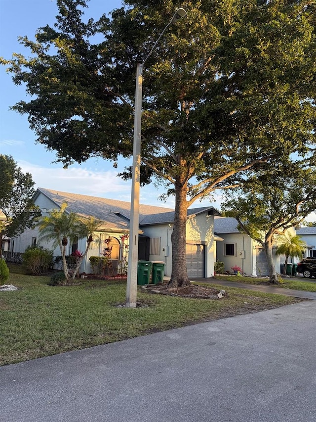 view of front of home featuring a garage and a front yard