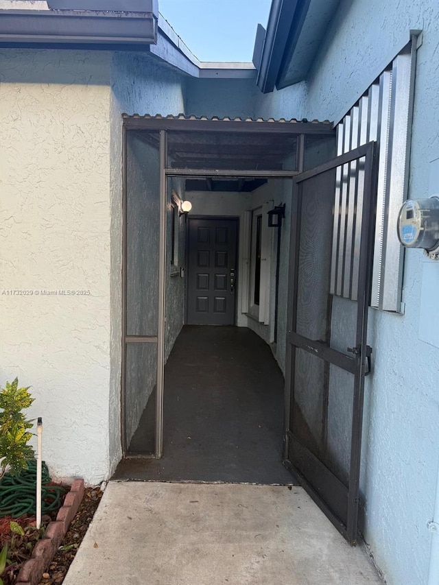 view of exterior entry featuring stucco siding