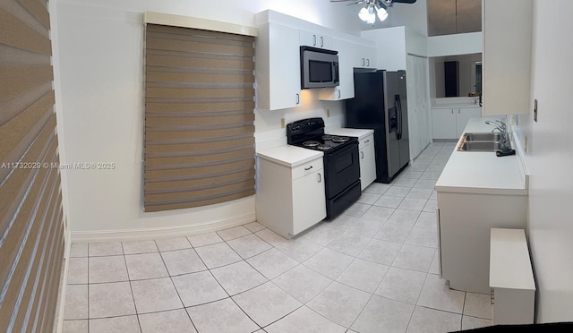 kitchen featuring stainless steel microwave, light countertops, black range with electric cooktop, refrigerator with ice dispenser, and a sink
