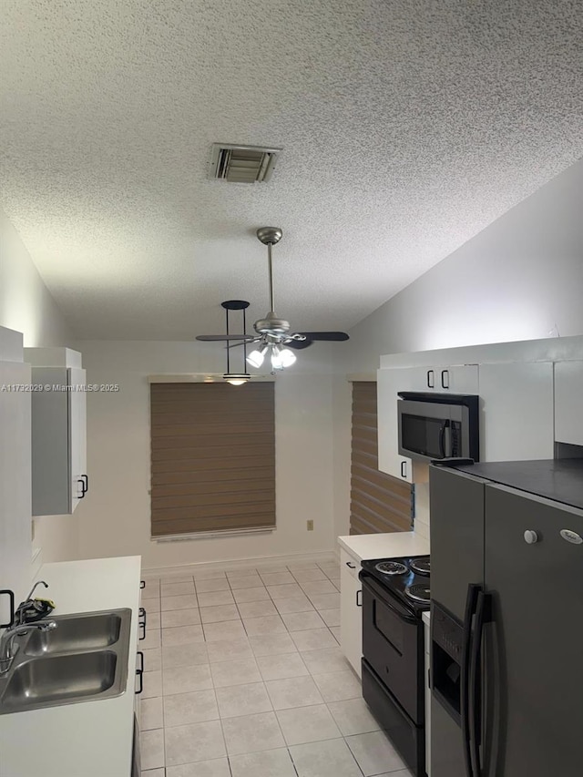 kitchen with a sink, a textured ceiling, black appliances, and ceiling fan