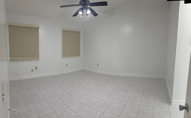 spare room featuring ceiling fan, a textured ceiling, and light tile patterned floors